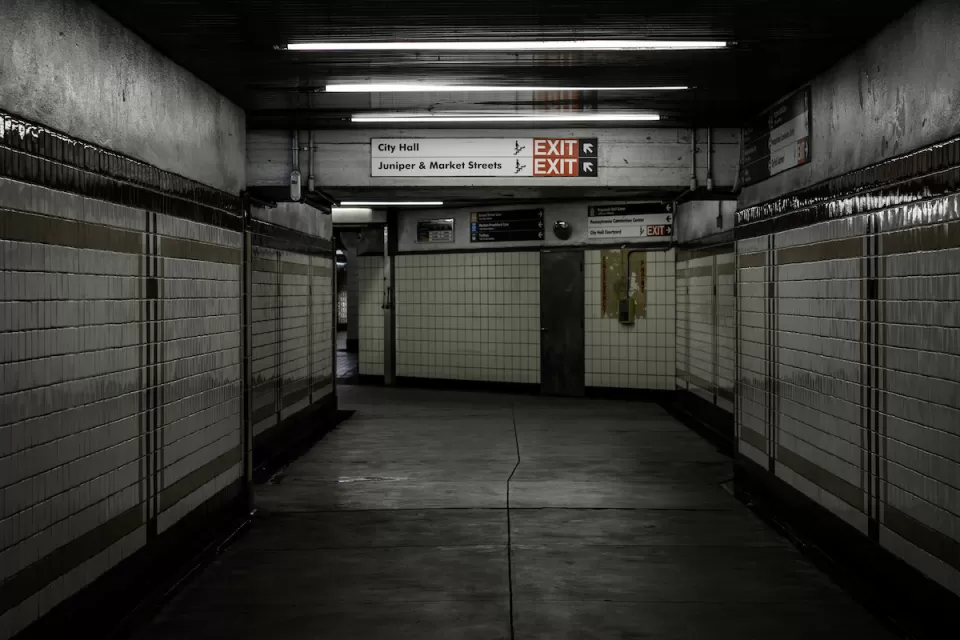 Empty hallway lined with white tile in subway station in Philadelphia, Pennsylvania.